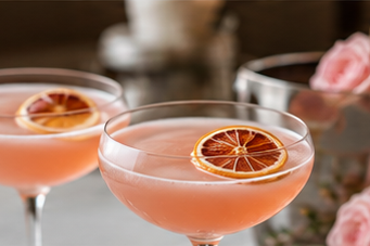 Concept image of pink drinks garnished with citrus